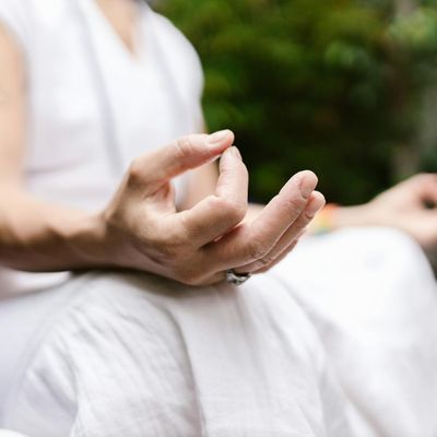 Close-up of hands in a mudra position during meditation.