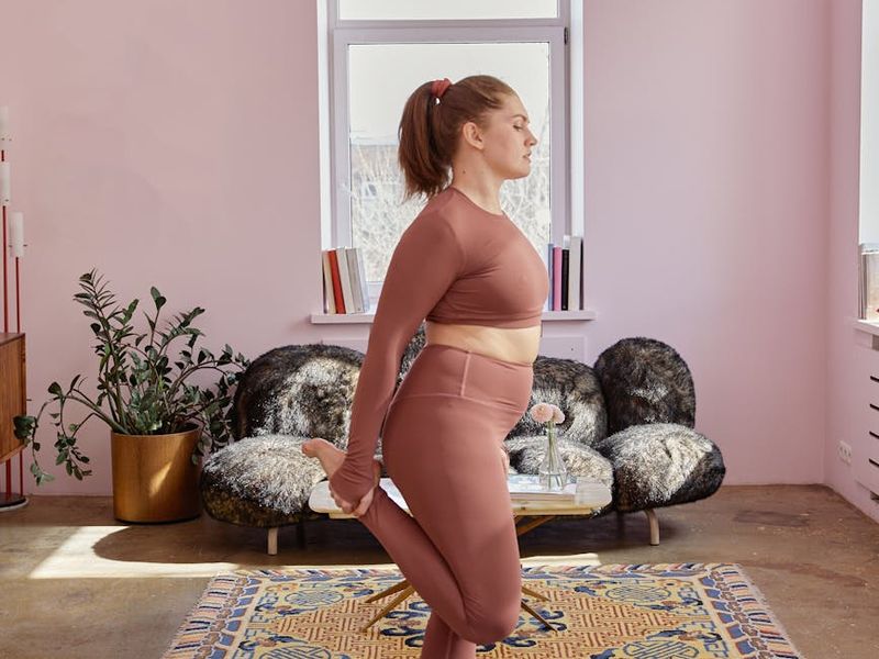 Person practicing a focused yoga sequence in a minimalist room.