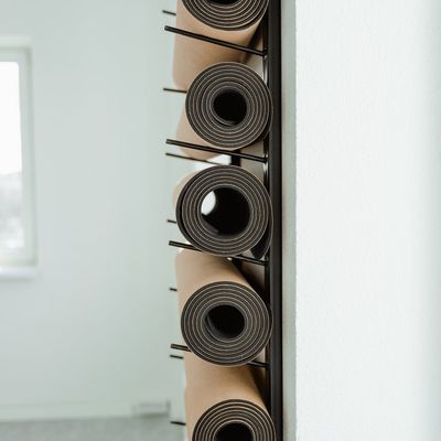 Yoga mat and accessories neatly arranged in a calm room.